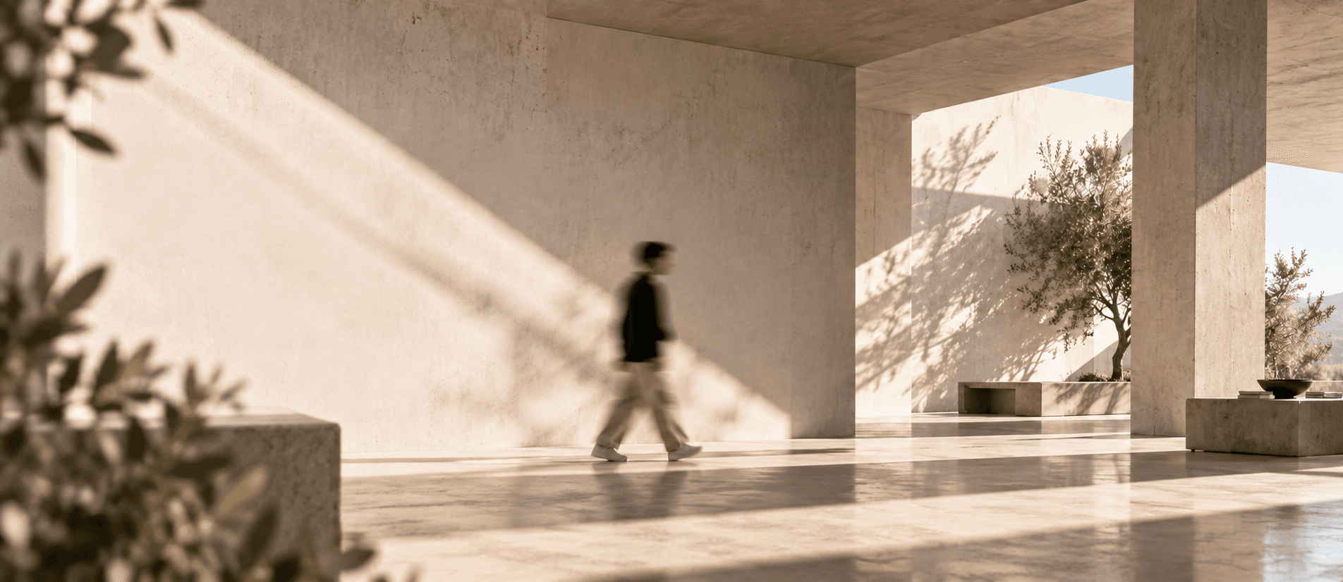 A person walking through a sunlit modern architectural studio